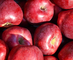 Red apples piled closely together.
