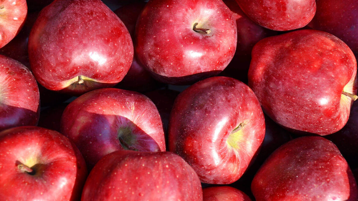 Red apples piled closely together.