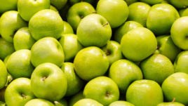 Pile of fresh green apples close-up.