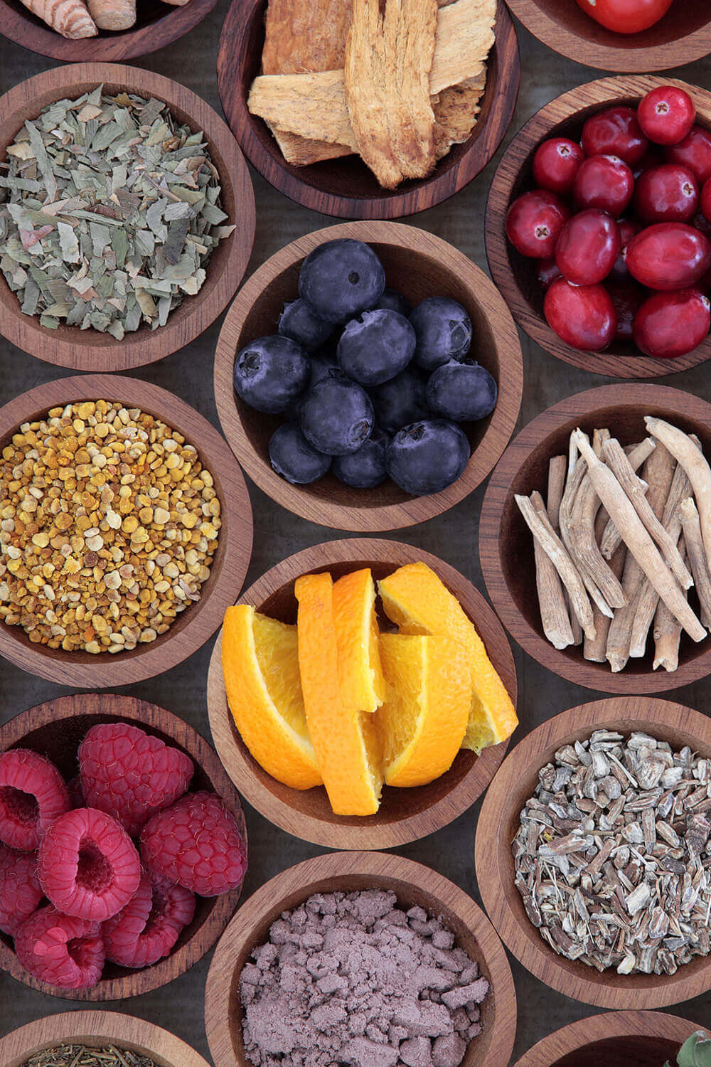 Bowls of assorted berries, herbs, and spices.