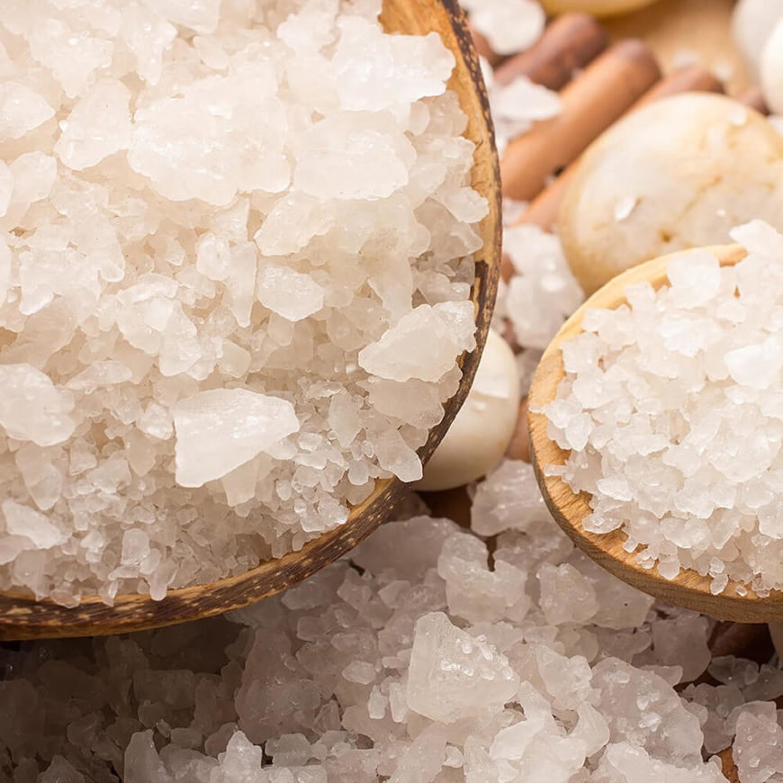 Coarse sea salt in wooden bowls.