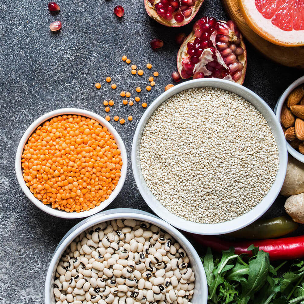 Assorted grains, legumes, nuts, and fruits display.