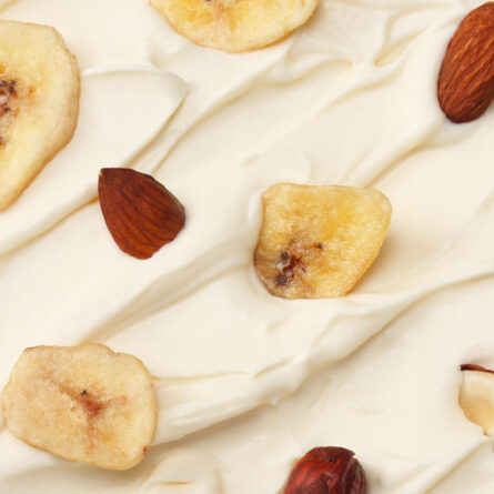 Yogurt topped with banana chips and nuts.
