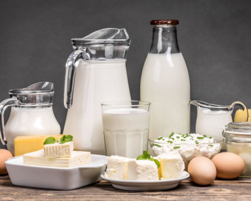 Dairy products assortment on wooden table.