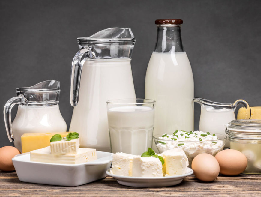 Dairy products assortment on wooden table.