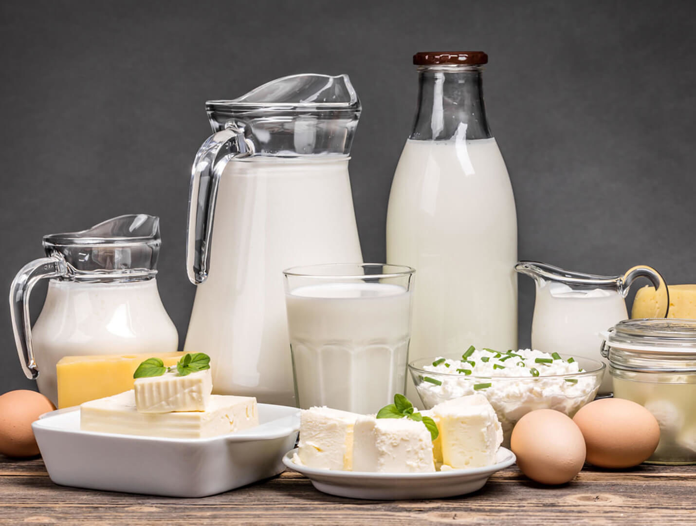 Dairy products assortment on wooden table.